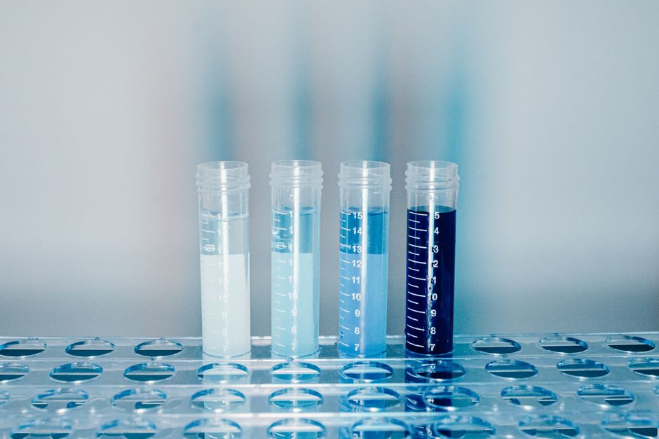 Close-up of test tubes filled with colorful liquids in a laboratory setting.